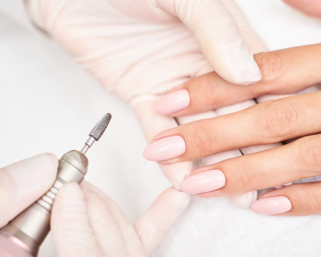 Close-up of a Russian manicure being performed on natural nails using professional sterilized tools at a Toronto nail salon.
