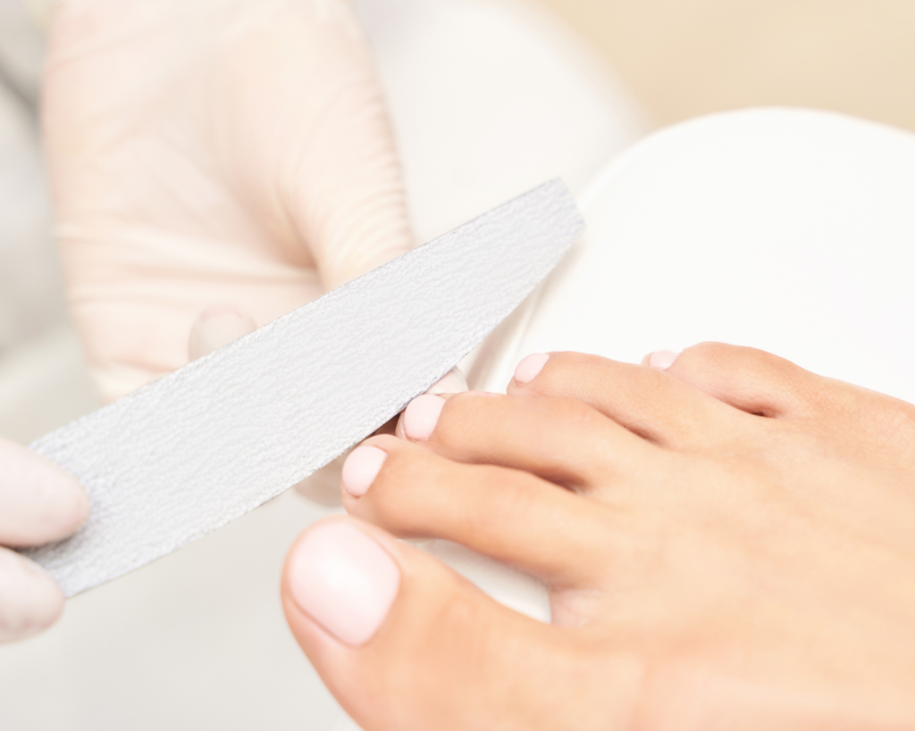 Professional dry pedicure service with precision nail shaping and detailed foot care performed using hygienic salon protocols.