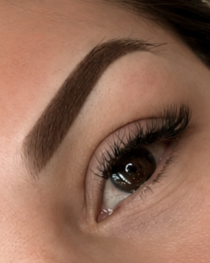 Close-up of soft, defined powder brows with natural-looking shading, showcasing permanent makeup by Sen Beauty in Toronto.